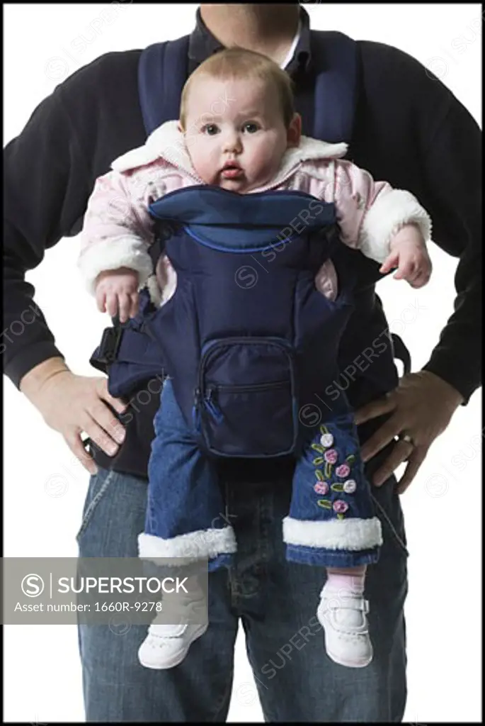 Mid section view of a mature man carrying his daughter