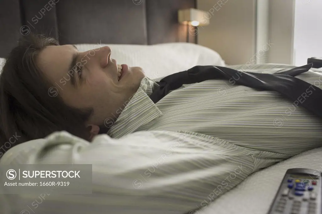 Close-up of a businessman lying on the bed