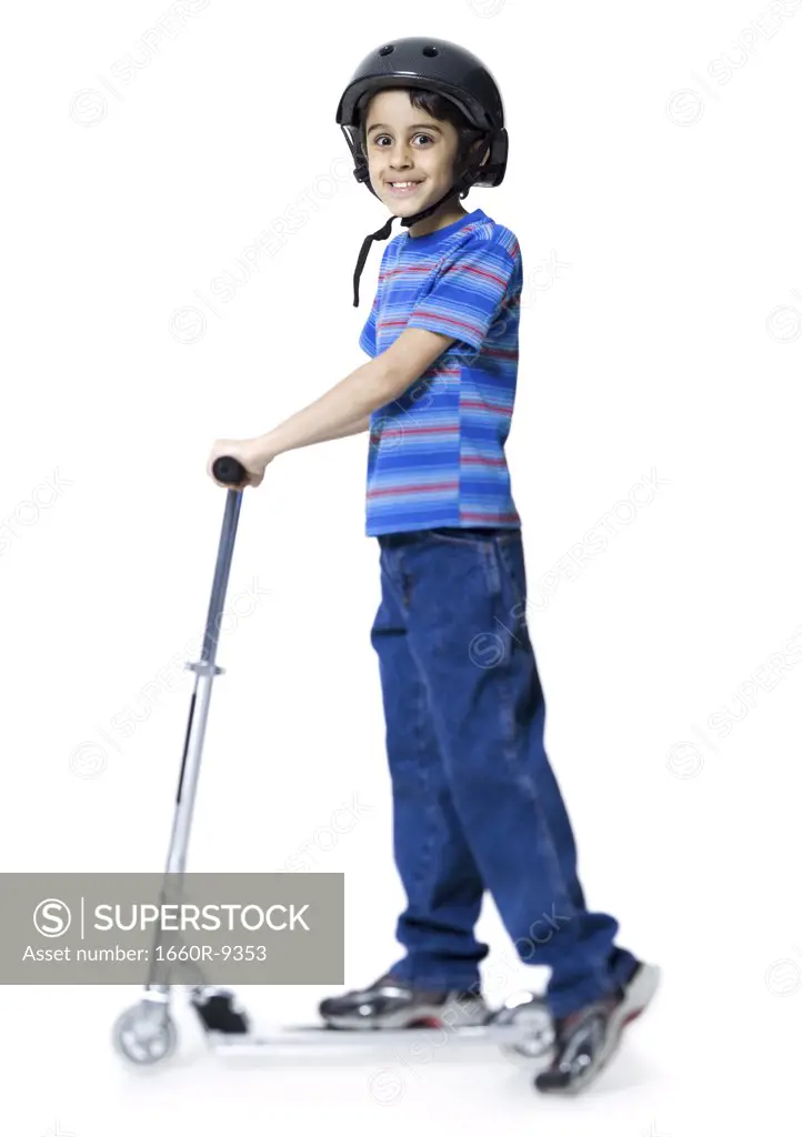 Profile of a boy riding a push scooter