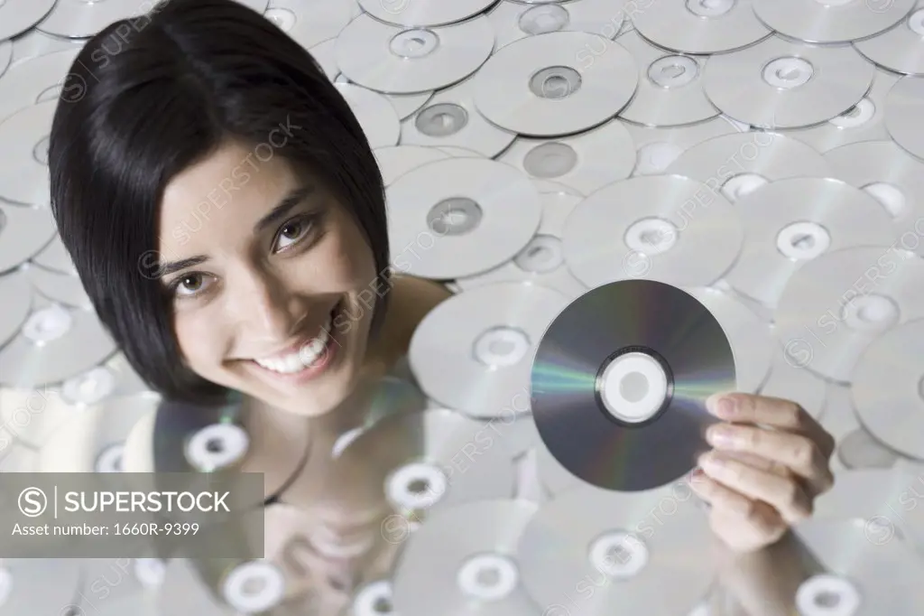 Portrait of a young woman holding a CD