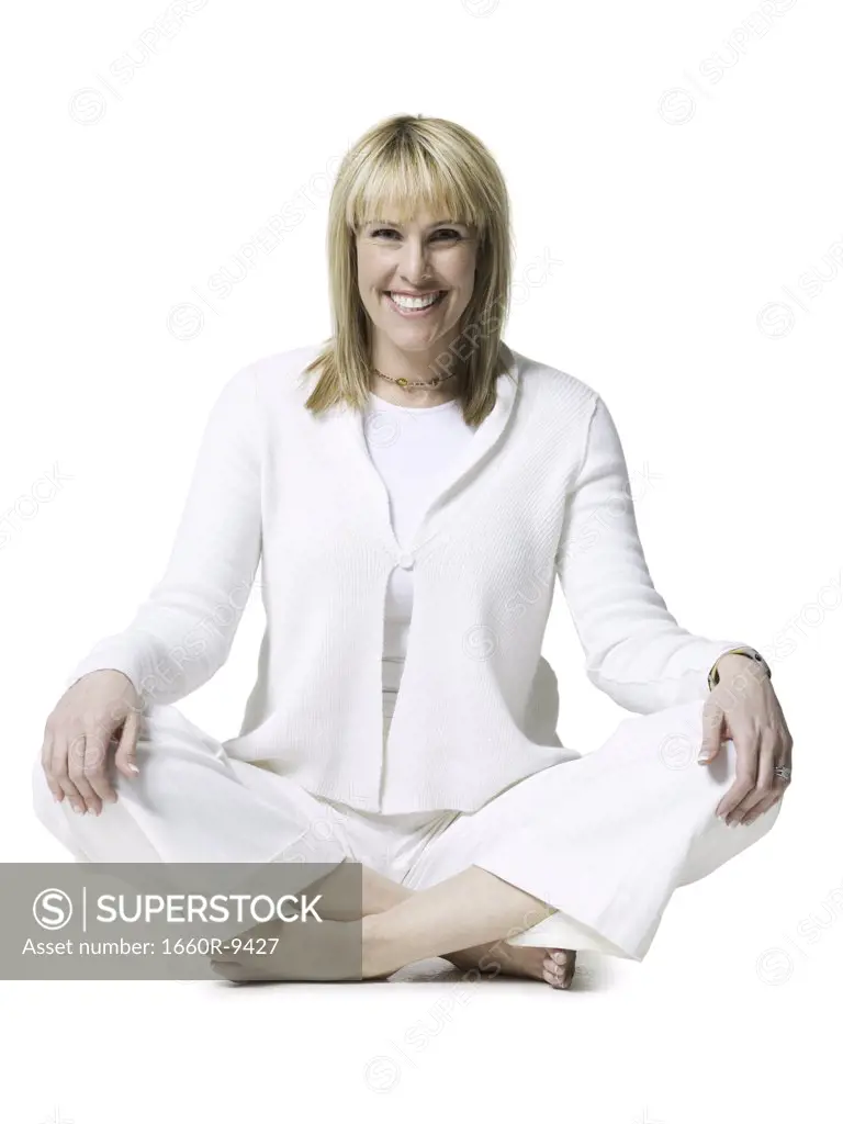 Portrait of a mid adult woman sitting in the lotus position