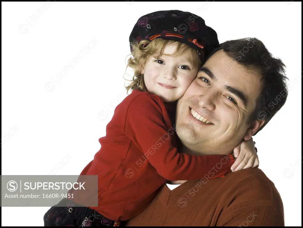 Close-up of a girl hugging her father