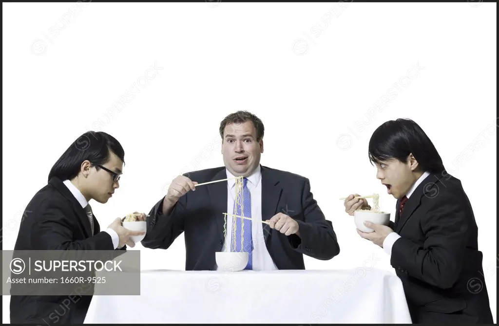 Three businessmen eating noodles