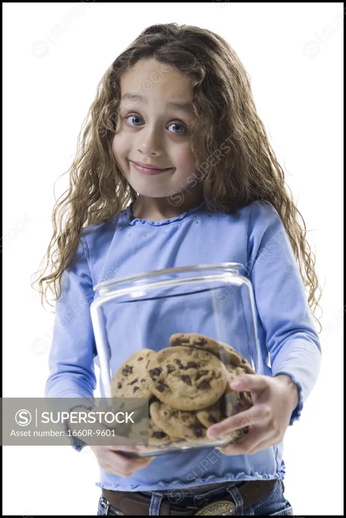 Portrait of a girl holding a jar of cookies