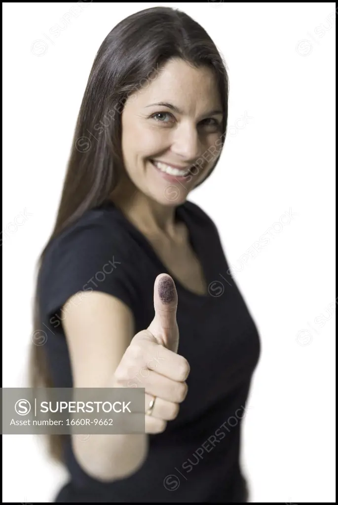 Portrait of a mid adult woman showing a thumbs up sign