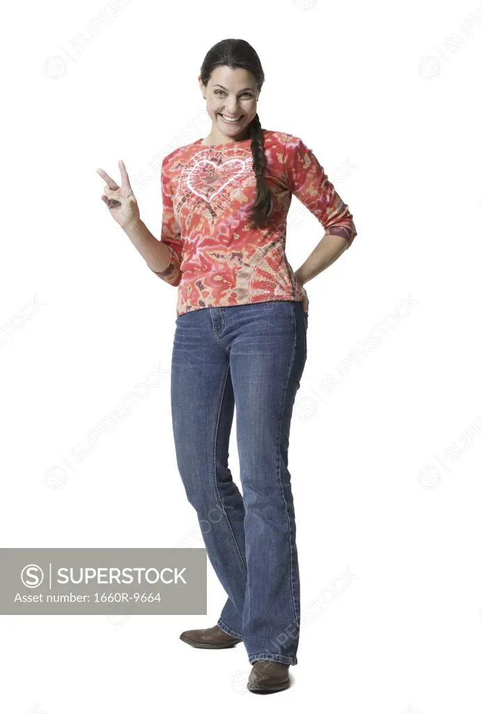 Portrait of a woman standing giving the peace sign