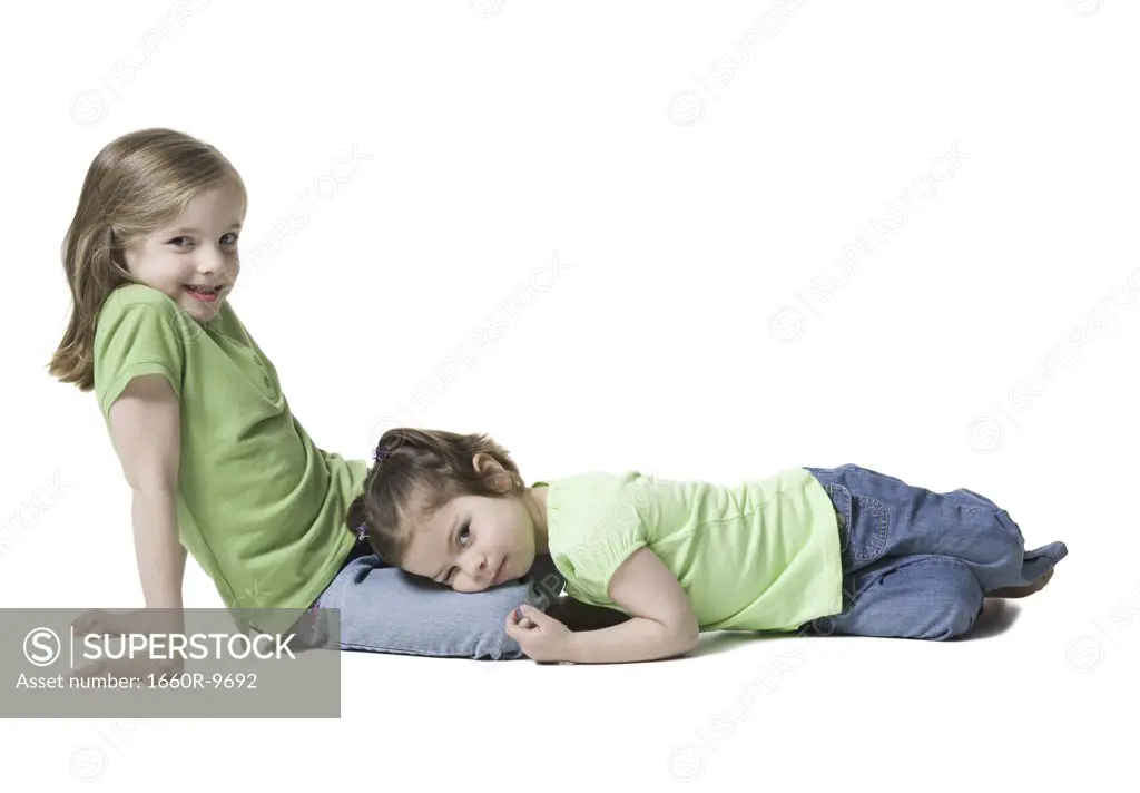 Portrait of a girl lying on her sister's lap