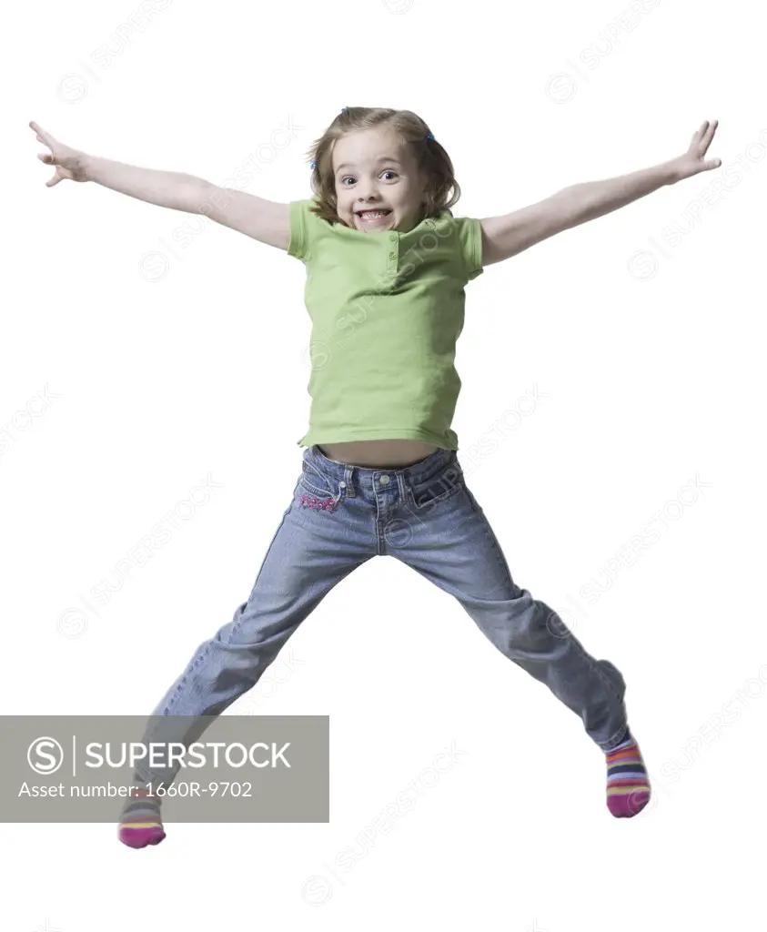 Portrait of a girl jumping in air with her arms outstretched