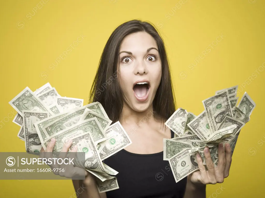 Close-up of a woman holding American dollar bills
