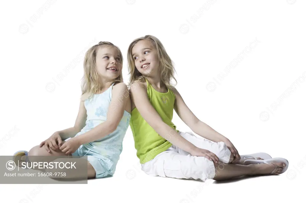 Two sisters looking at each other and smiling
