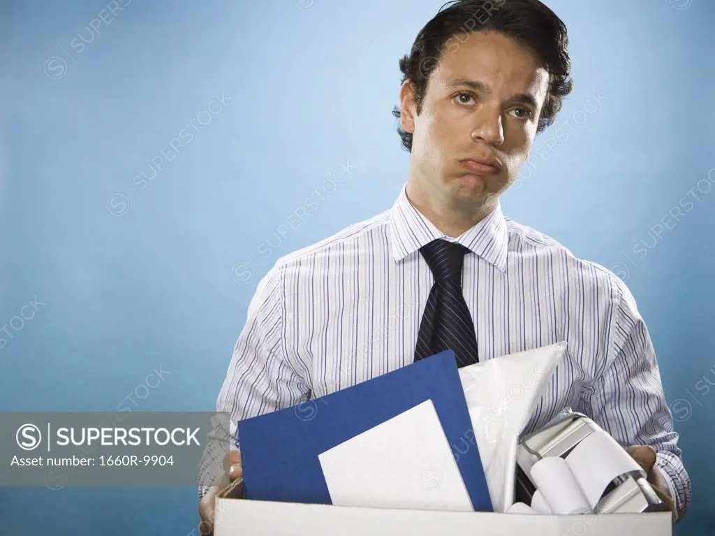 Portrait of a businessman holding a cardboard box