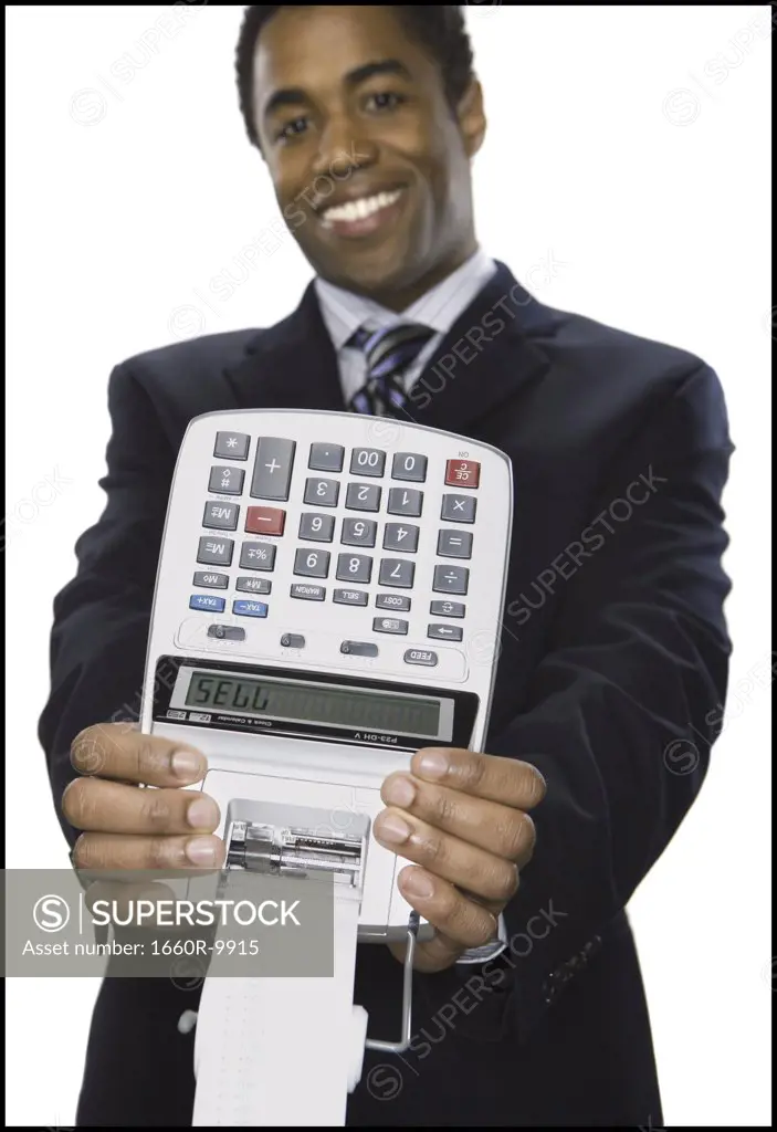 Portrait of a businessman holding an adding machine with the numeric text "SELL"