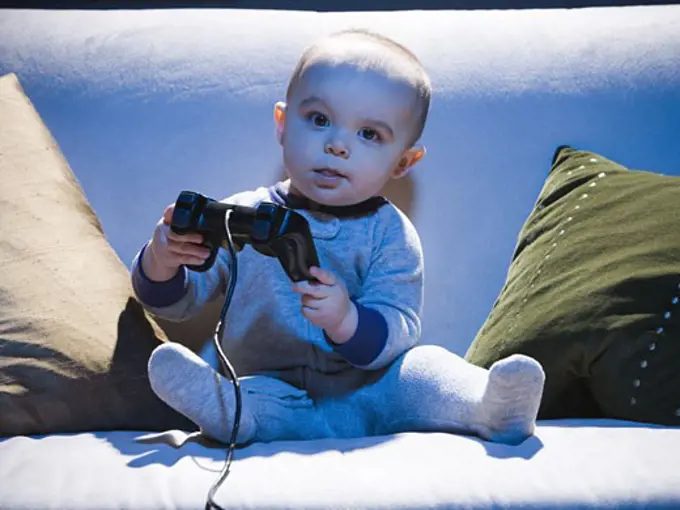 Baby on sofa with video game controller
