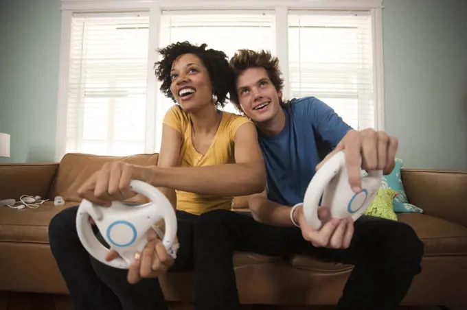 USA, Utah, Provo, young couple playing video games in living room
