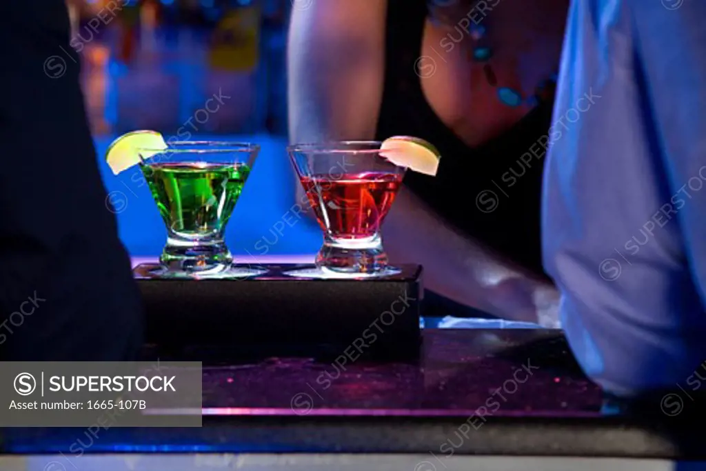 Close-up of two cocktails on a bar counter