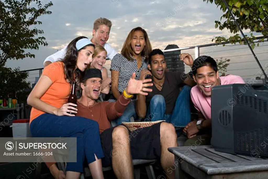 Group of women and men watching television