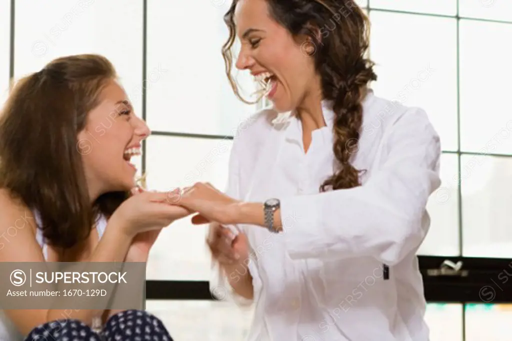 Close-up of two young women laughing