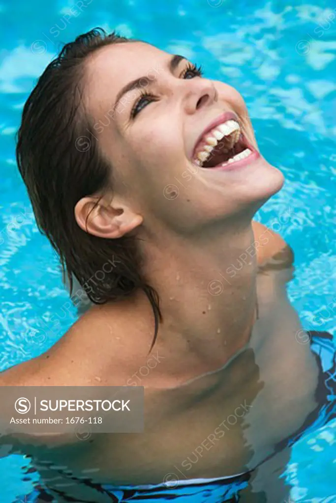 Close-up of a young woman looking up in a swimming pool