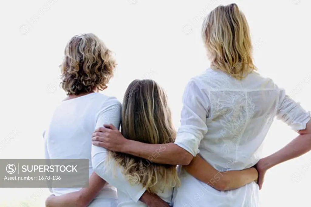 Rear view of a girl standing with her mother and grandmother