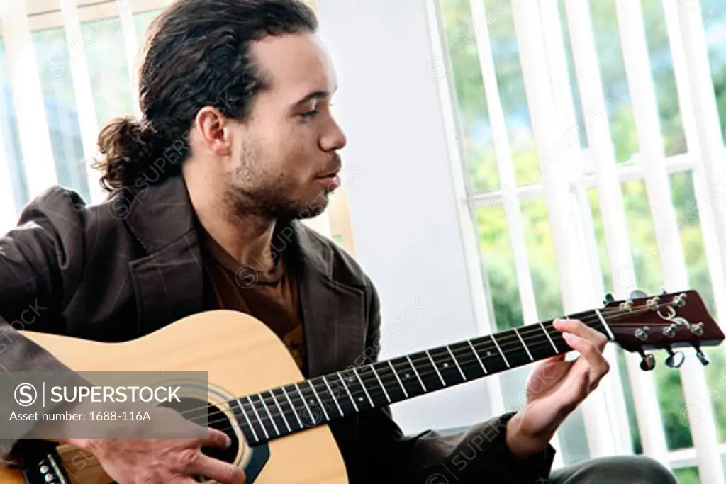 Young man playing a guitar