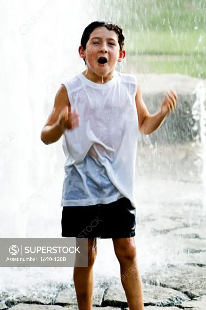 Boy playing in a fountain