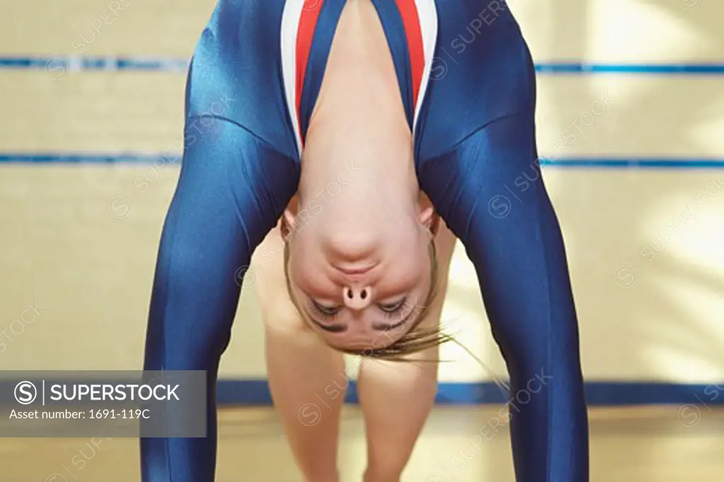 Female gymnast bending backwards