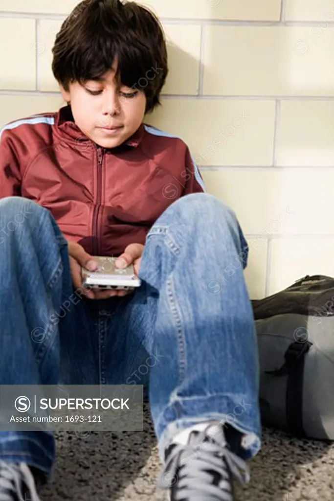 Boy playing with a handheld video game