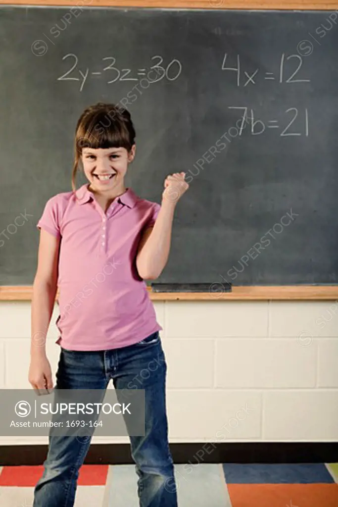 Girl standing in front if a chalkboard