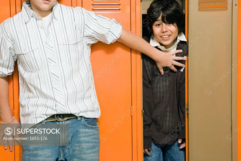 Boy holding another boy in a locker