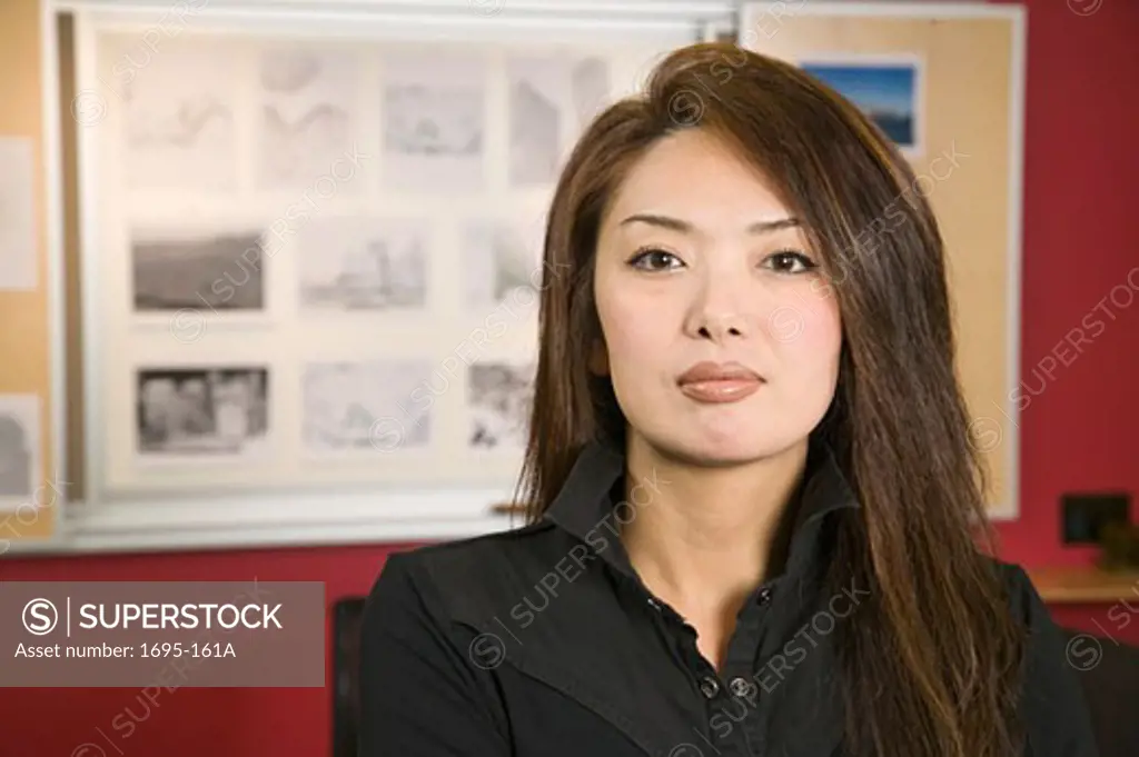 Portrait of a businesswoman with designs behind her