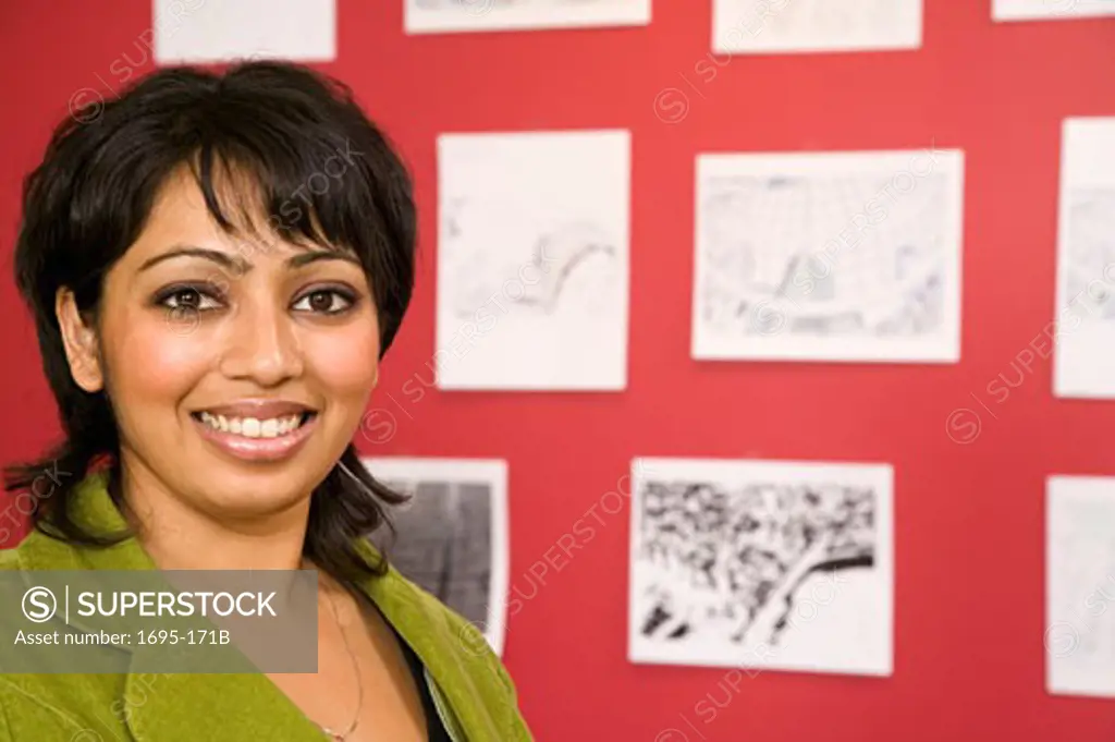 Portrait of a businesswoman smiling in front of designs