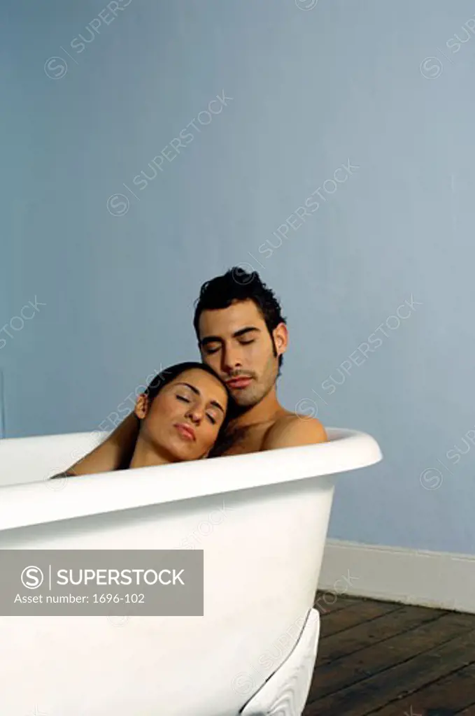 Young couple reclining in a bathtub