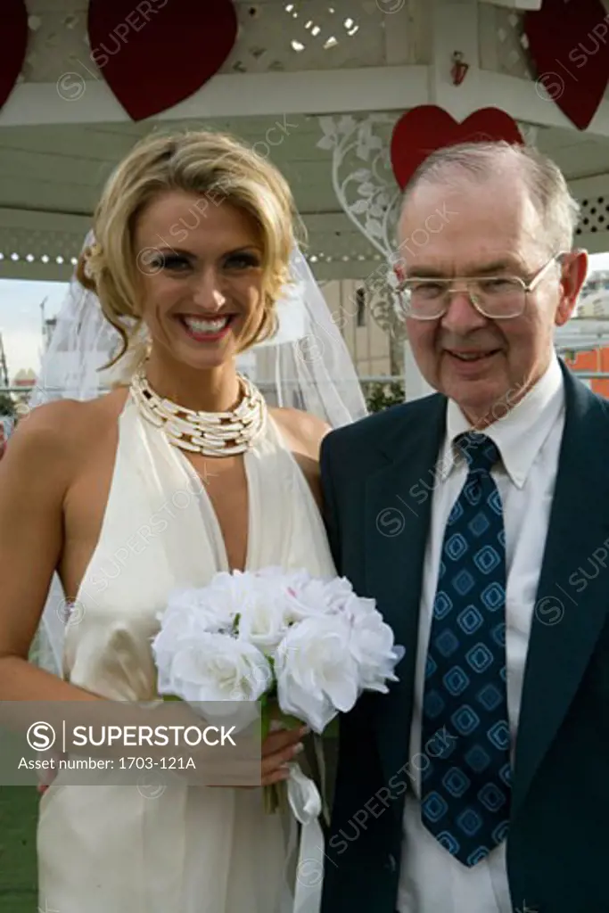 Bride standing with a senior man and smiling