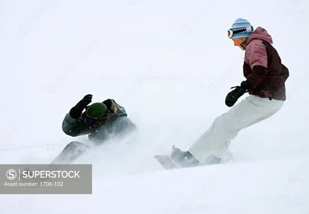 Mid adult couple snowboarding