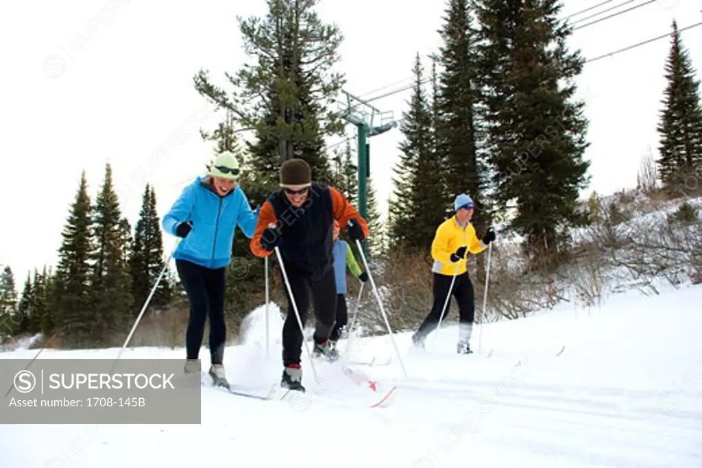 Four people skiing