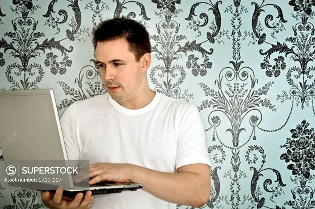Mid adult man using a laptop