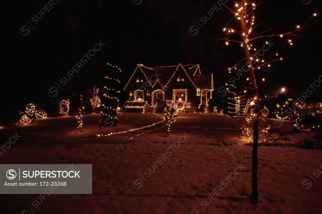 House with Christmas lights lit up at night