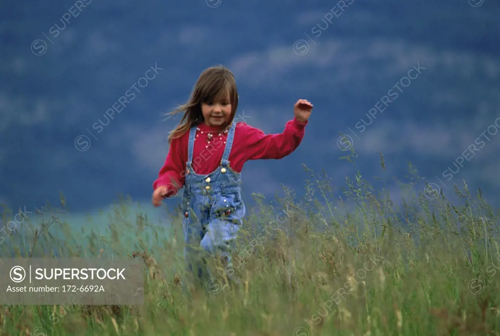 girl running through field