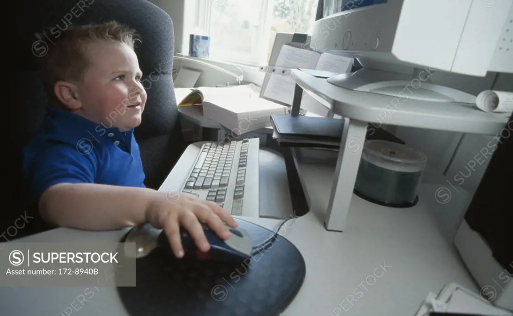 Side profile of a boy using a computer
