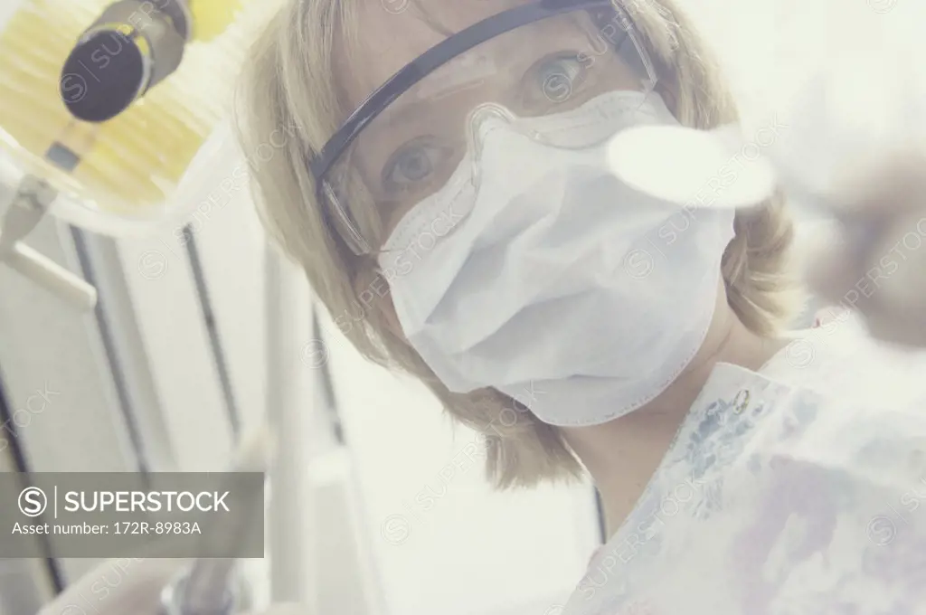 Young female dentist holding a syringe