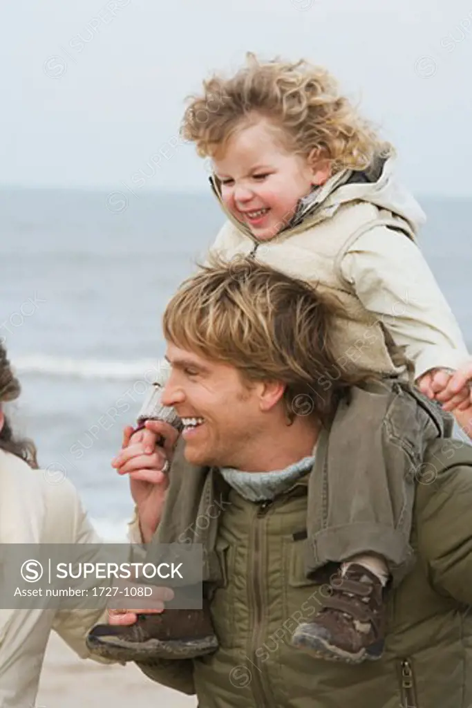 Mid adult couple with their son on the beach