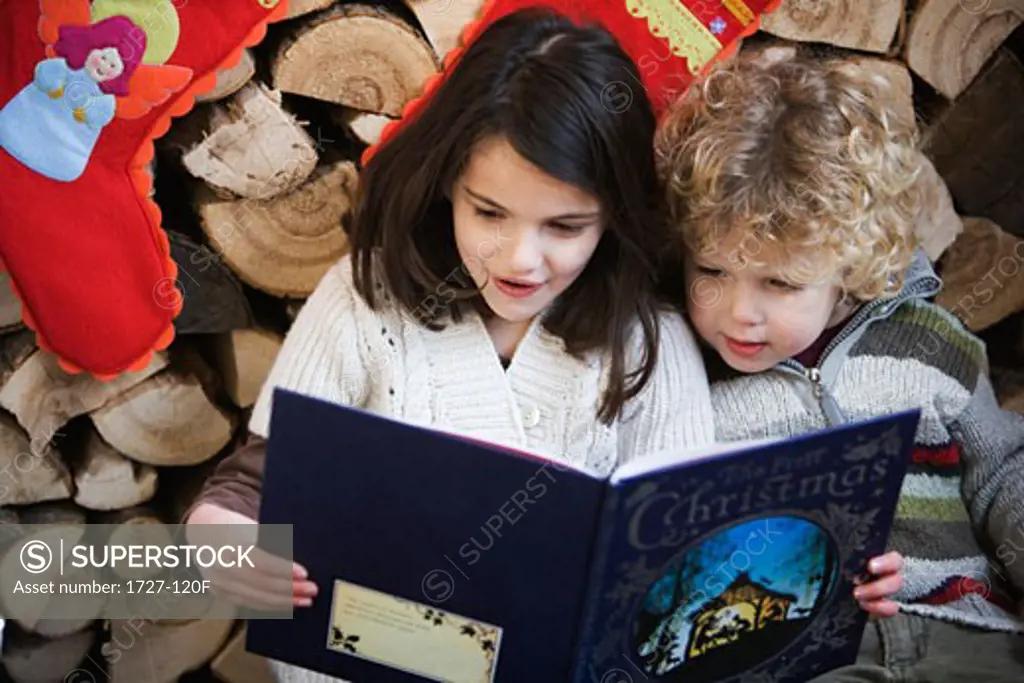 Girl and boy reading a book