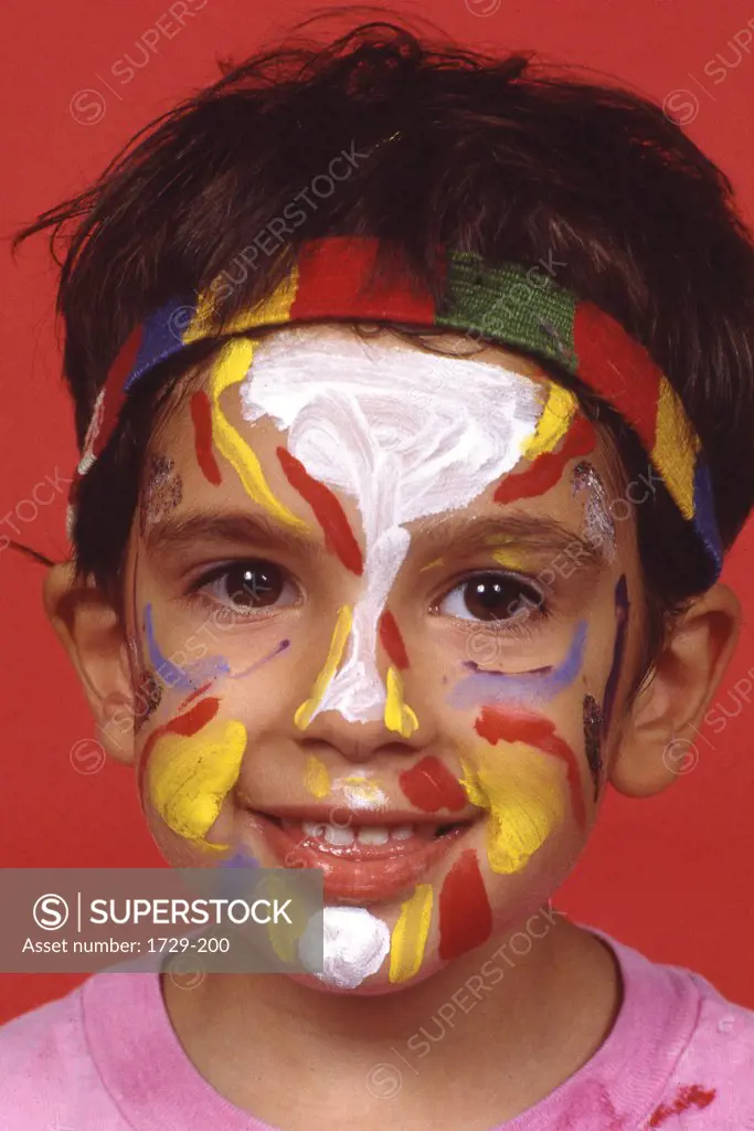 Portrait of a boy smiling with painted face