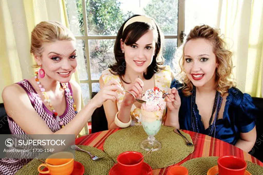 Three young women eating ice cream