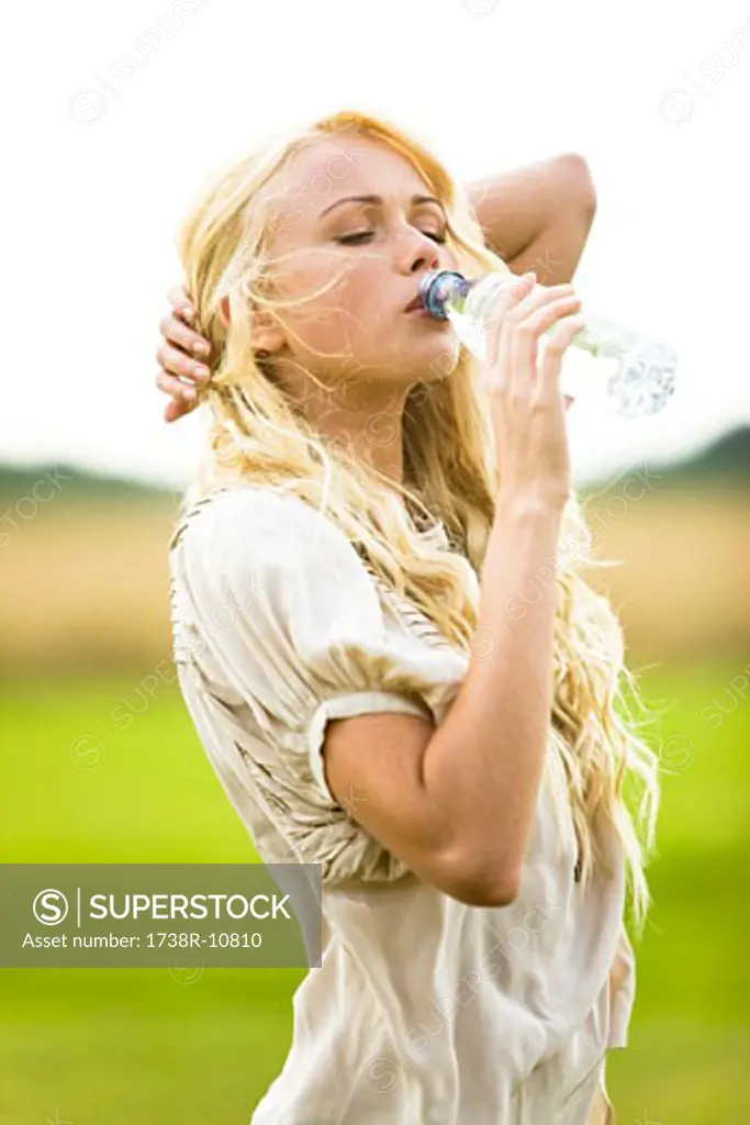 Young woman drinking water from a bottle