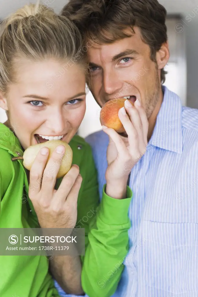 Close-up of a couple eating fruits