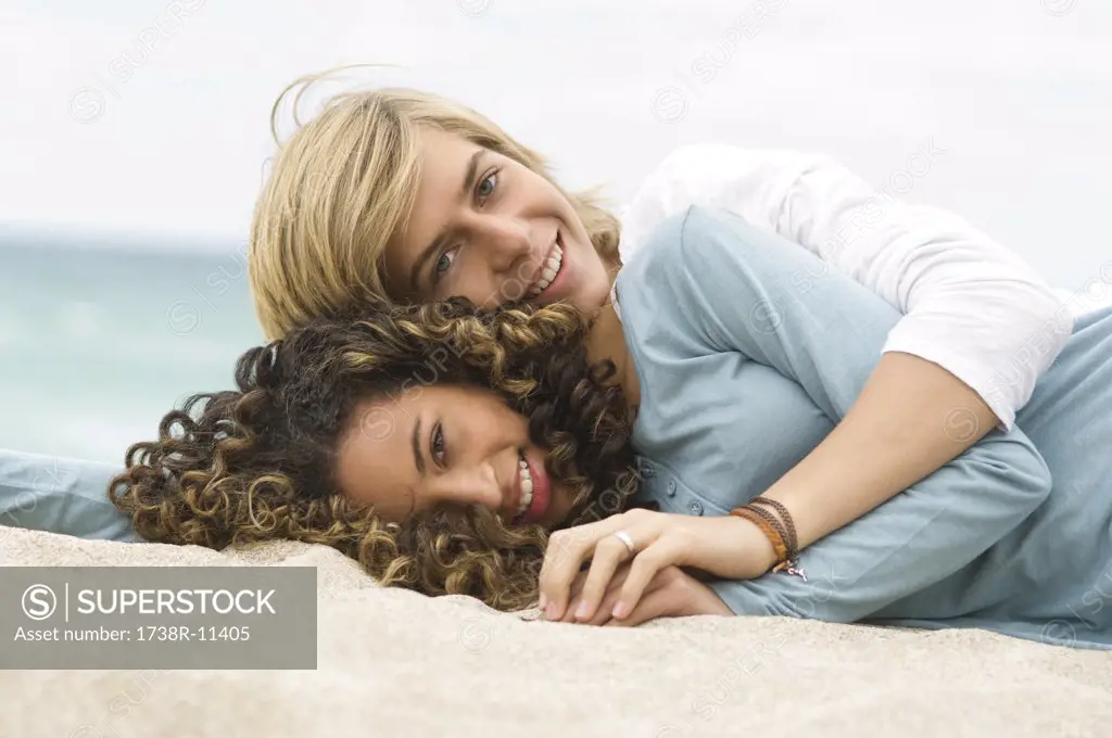 Teenage boy and a girl relaxing on the beach