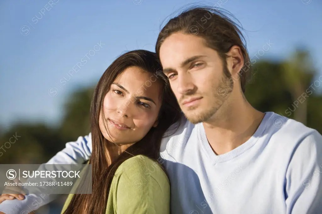 Close-up of a man with his arm around a woman