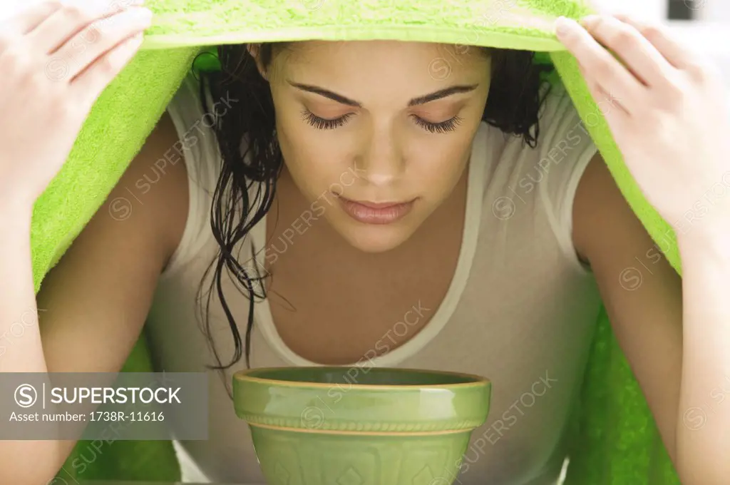 Woman inhaling over a bowl