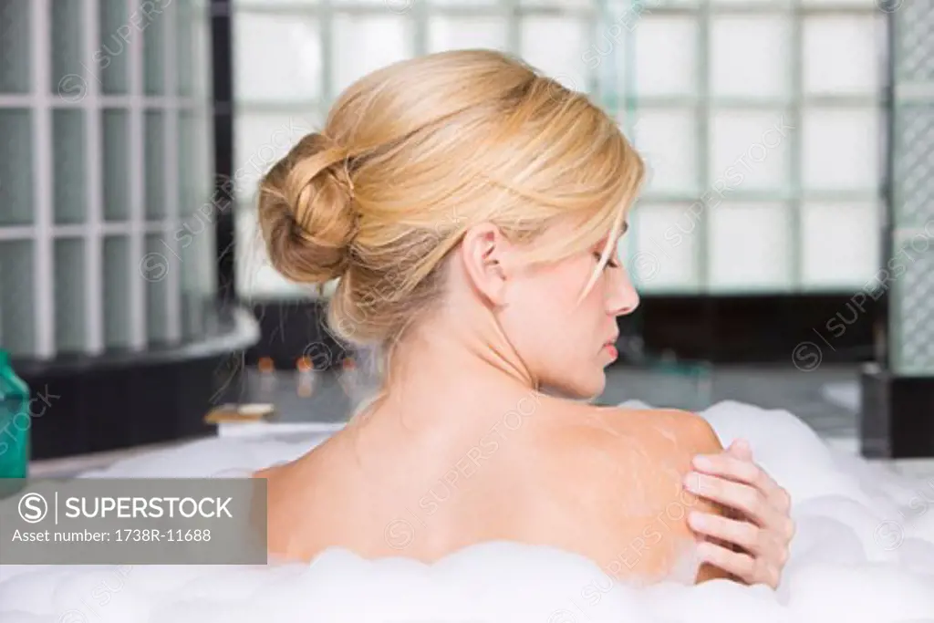 Woman taking a bubble bath